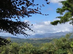 a view of a valley with mountains in the distance at Rowantree in Kiltarlty +1 photo