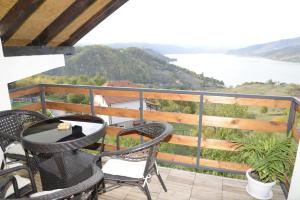 a balcony with chairs and a view of the water at Apartment Danubius 2 in Donji Milanovac