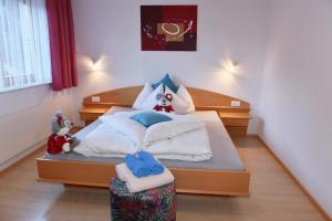 a bedroom with a bed with stuffed animals on it at Haus Carnot in Samnaun