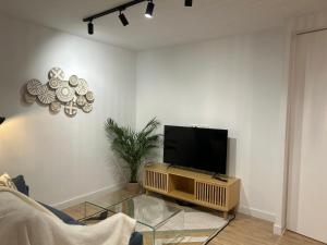 a living room with a flat screen tv on a table at Loft Atemporal, centro de Ciudad Real in Ciudad Real