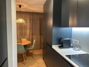 a kitchen with a table and a dining room at Loft Atemporal, centro de Ciudad Real in Ciudad Real +28 photos