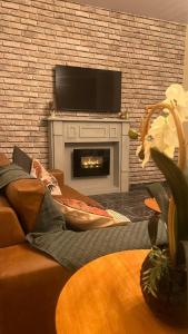 a living room with a fireplace with a flat screen tv at Casa Naza in Areia