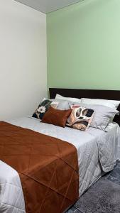 a bedroom with a large bed with pillows on it at Casa Naza in Areia