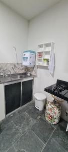 a kitchen with a sink and a toilet at Quartos Individuais Privativos in Barueri