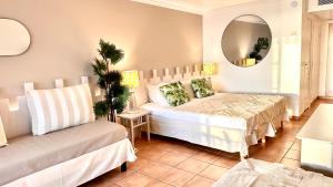 a bedroom with two beds and a mirror at Grenade 21 vue mer proche plage dans Complexe type Village Vacances in Sainte-Luce