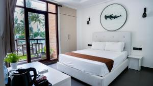 Postel nebo postele na pokoji v ubytování Silver Oasis Maldives
