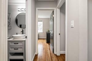 a bathroom with a sink and a mirror at Fenced Yard, Swing Set Pawfect for Family and Dogs! in Srmc Heliport +53 photos