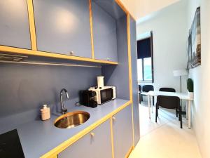 a kitchen with a sink and a microwave on a counter at Fisherman Blues in Matosinhos
