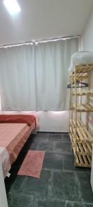 a bedroom with a bed and a ladder and a shelf at Quartos Individuais Privativos in Barueri +12 photos