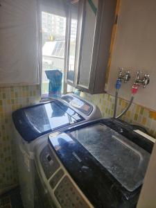 a washing machine sitting in a kitchen next to a window at Suyu Station Motel in Seoul +21 photos