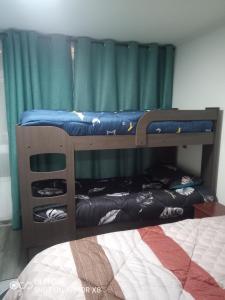 two bunk beds in a room with a bed at DeptoIquique in Iquique