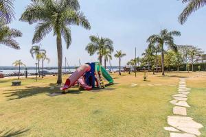 a playground with a slide in a park with palm trees at BSB STAY Flats Particulares - Life Resort SHTN in Brasilia