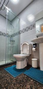 a bathroom with a toilet and a glass shower at appart FAMILY 3 BEDROOM en face city sport tanger in Branes +39 photos