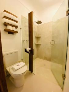 a bathroom with a toilet and a glass shower at Hotel Amaca Puerto Vallarta - Adults Only in Puerto Vallarta +203 photos