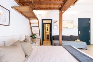 a bedroom with a bed and a ladder at Oli by Unik Vacation in Tarragona