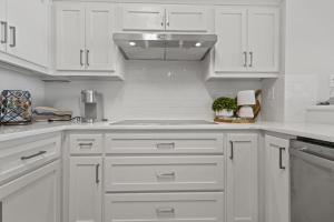 a white kitchen with white cabinets and a stove at Perdido Dunes Tower 6E condo in Orange Beach