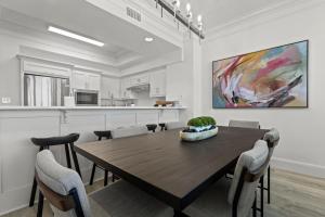 a dining room with a wooden table and chairs at Perdido Dunes Tower 6E condo in Orange Beach