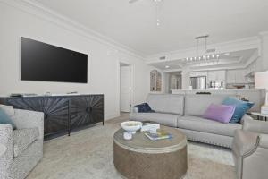 a living room with a couch and a tv at Perdido Dunes Tower 6E condo in Orange Beach +48 photos