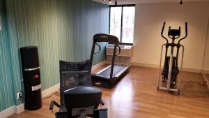 a room with a gym with a treadmill and a window at Holiday Inn Express Rochester-Greece in Greece