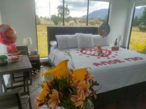 a bedroom with a bed with flowers on it at Suite Campestre Sauna Jacuzzi in Palo Verde