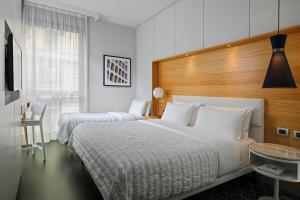 Postel nebo postele na pokoji v ubytování Le Meridien Visconti Rome