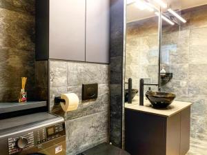 a bathroom with a sink and a counter with a bowl at City Vibe Apartments in Someşeni