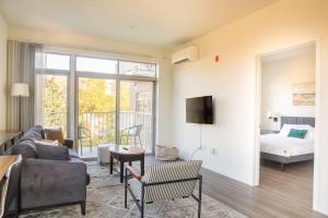a living room with a couch and a bed at East Side Luxury 1BR Apt - Near Brady and Fiserv with Balcony in Milwaukee +11 photos