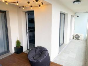 a living room with a bean bag chair in front of a wall at City Vibe Apartments in Someşeni