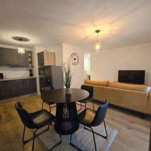 a living room with a table and chairs and a couch at L'Apaisant in Thonon-les-Bains