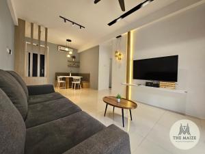 a living room with a couch and a tv at The Cove Hillside Residence Ipoh - Tranquility Vibes in Ipoh