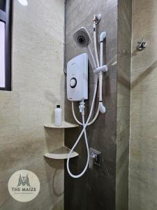 a shower in a bathroom with a hair dryer at The Cove Hillside Residence Ipoh - Tranquility Vibes in Ipoh