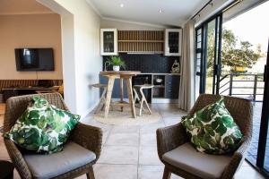 a living room with two chairs and a table at Rustfontein Guest Farm and Venue in Malmesbury