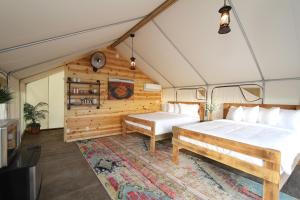 a bedroom with a bed and a bench in a room at Glamping Tent #7 with AC Heat AC and Private Bath in Orderville