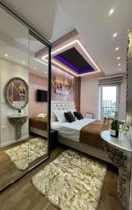 a bedroom with a large bed and a mirror at Imperial Lux Apartment in Kragujevac