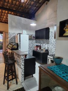 a kitchen with a refrigerator and a counter top at Katai in Salvador