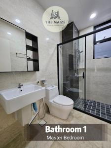 a bathroom with a toilet and a sink and a shower at The Cove Ipoh - Blissful Abodes in Tambun