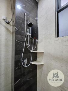 a shower in a bathroom with shelves on the wall at The Cove Ipoh - Blissful Abodes in Tambun +16 photos