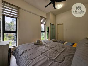 a large bed in a room with a ceiling fan at The Cove Ipoh - Blissful Abodes in Tambun