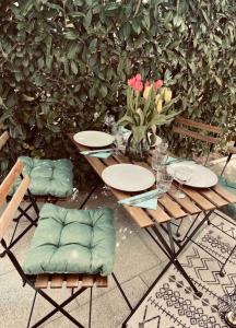 una mesa de madera con 2 sillas y un jarrón de flores en Einfamilienhaus im 5Seen-Land, en Wörthsee