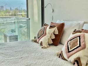 Una cama o camas en una habitación de Espacio Manquehue 14 fotos más