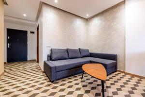 a living room with a blue couch and a table at City Vibe Apartments in Someşeni