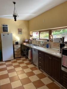 a kitchen with a white refrigerator and a tile floor at Montana in Suceviţa