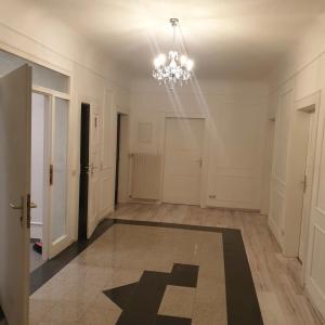 an empty hallway with a chandelier in a building at Leimen51 WG3 in Leimen +2 photos