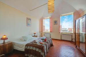 a bedroom with a bed with two stuffed animals on it at Ca Moretto - Happy Rentals in Sanremo