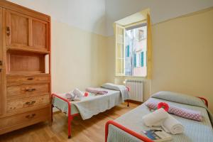 a small bedroom with two beds and a window at Ca Moretto - Happy Rentals in Sanremo +34 photos