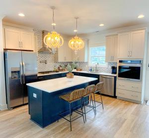 a kitchen with a blue island and chairs in it at Luxurious Lake Getaway in Winchester