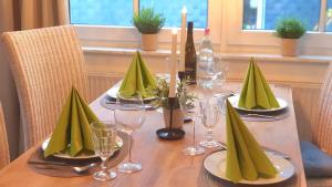 a table with wine bottles and glasses on it at Ferienwohnung "Harzblick" mit eigenem Balkon in Braunlage