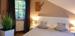 a bedroom with a bed with two pillows on it at Ferienwohnung "Harzblick" mit eigenem Balkon in Braunlage