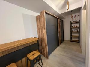 a hallway with a door and a stool in a room at City Vibe Apartments in Someşeni