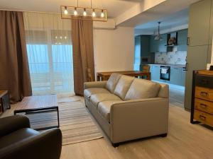 a living room with a couch and a table at City Vibe Apartments in Someşeni